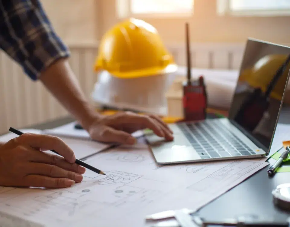 A construction worker looks over a blueprint for a current project